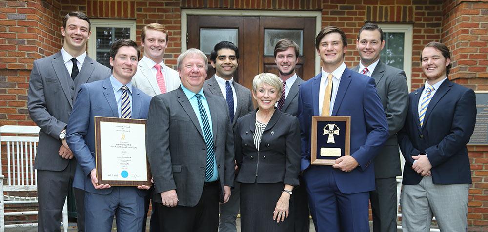 Junior Andrew Schaper, President Linda Flaherty-Goldsmith, Provost Dr. Brad Caskey, and senior William Heath.